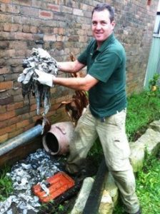 Darren clearing the blocked drain of the baby wipes